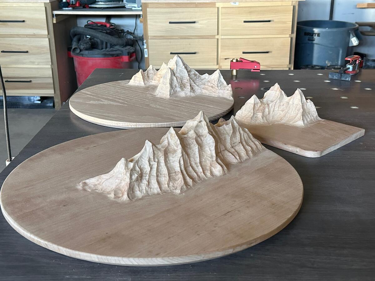 Three mountain pieces being carved in the workshop
